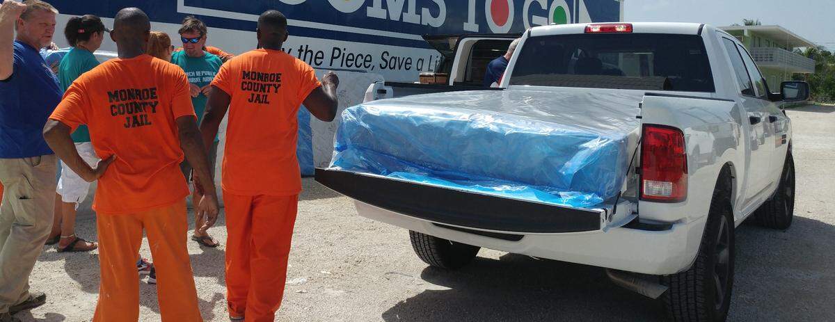 Monroe County jail inmates helped haul mattresses and sofas to trucks on Aug. 10, 2018, at a post-Hurricane Irma furniture giveaway event.