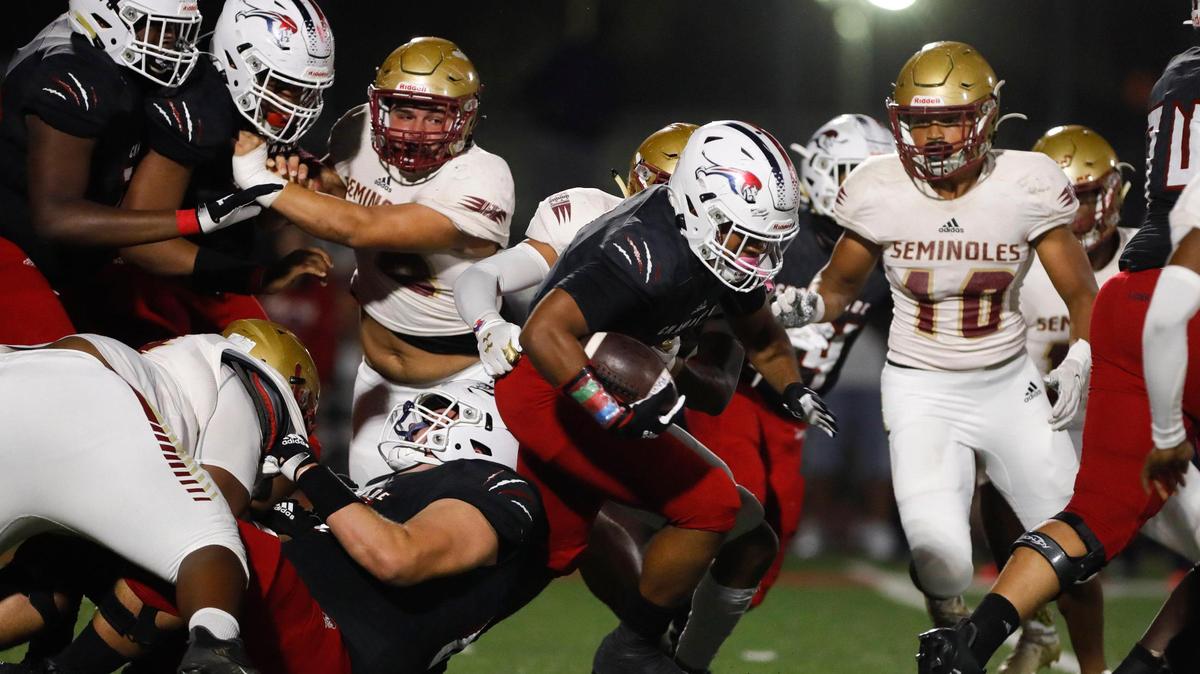 Chaminade-Madonna Lions running back Davion Gause (7) runs with the football against the FSU High School Seminoles during the first half of the Class 3A high school football semifinal game at Chaminade-Madonna Preparatory School in Hollywood, Florida, on Friday, December 3, 2021.