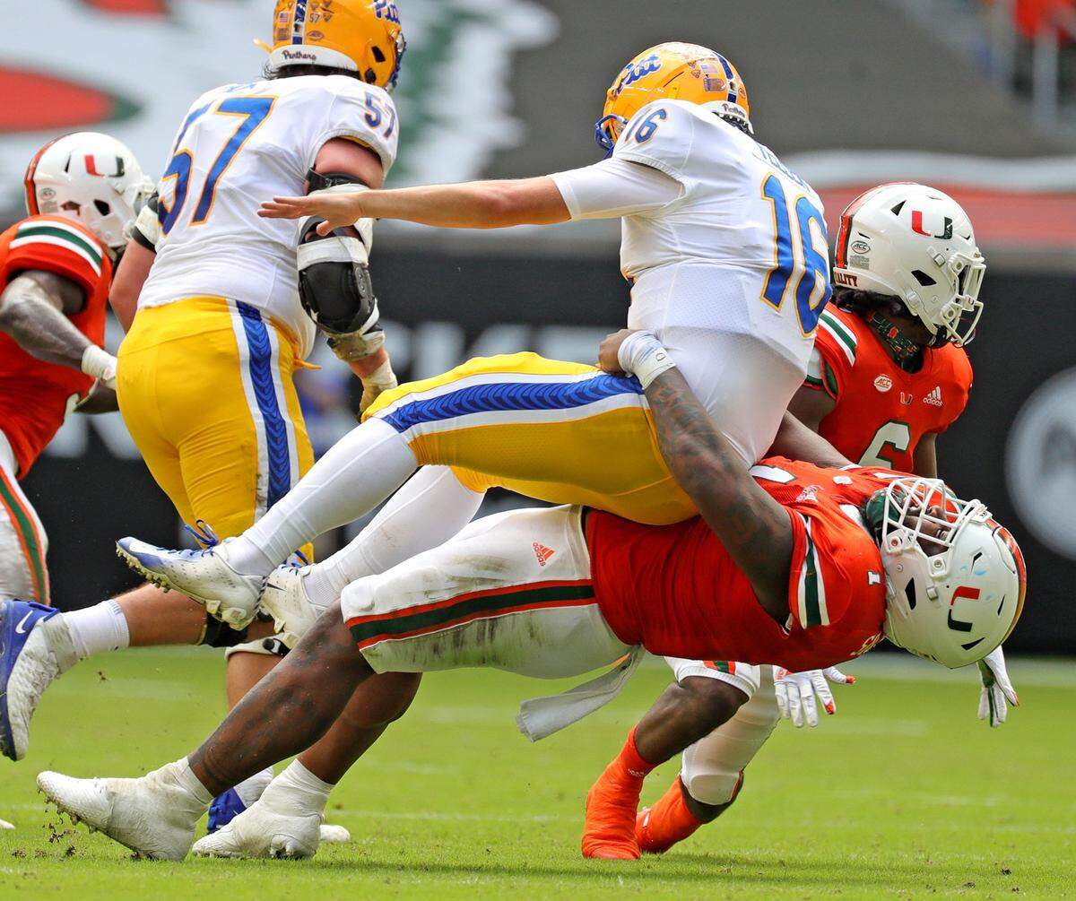 Miami Hurricanes defensive tackle Nesta Jade Silvera (1) tackles Pittsburg Panthers quarterback Joey Yellen (16) in the second quarter at Hard Rock Stadium in Miami Gardens, Florida, Saturday, October 17, 2020.