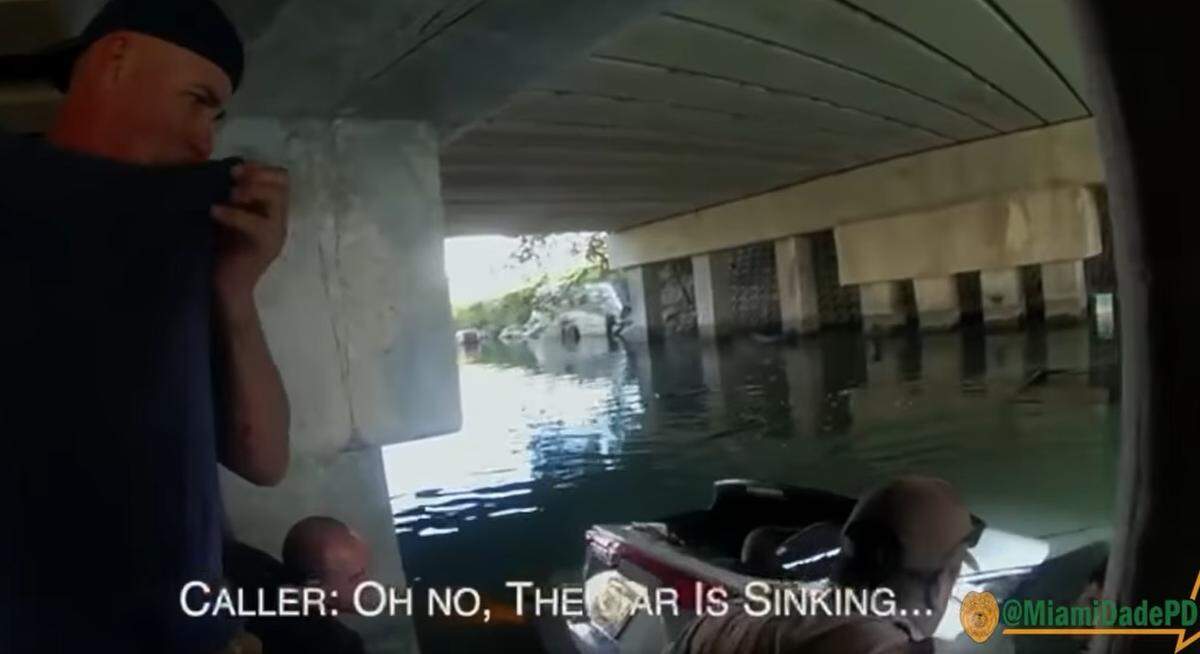 Miami-Dade Police release bodycam video footage of child’s rescue from a car that was sinking in a canal near Southwest 232nd Street and 127th Avenue on Feb. 27. This is a screenshot from the video.