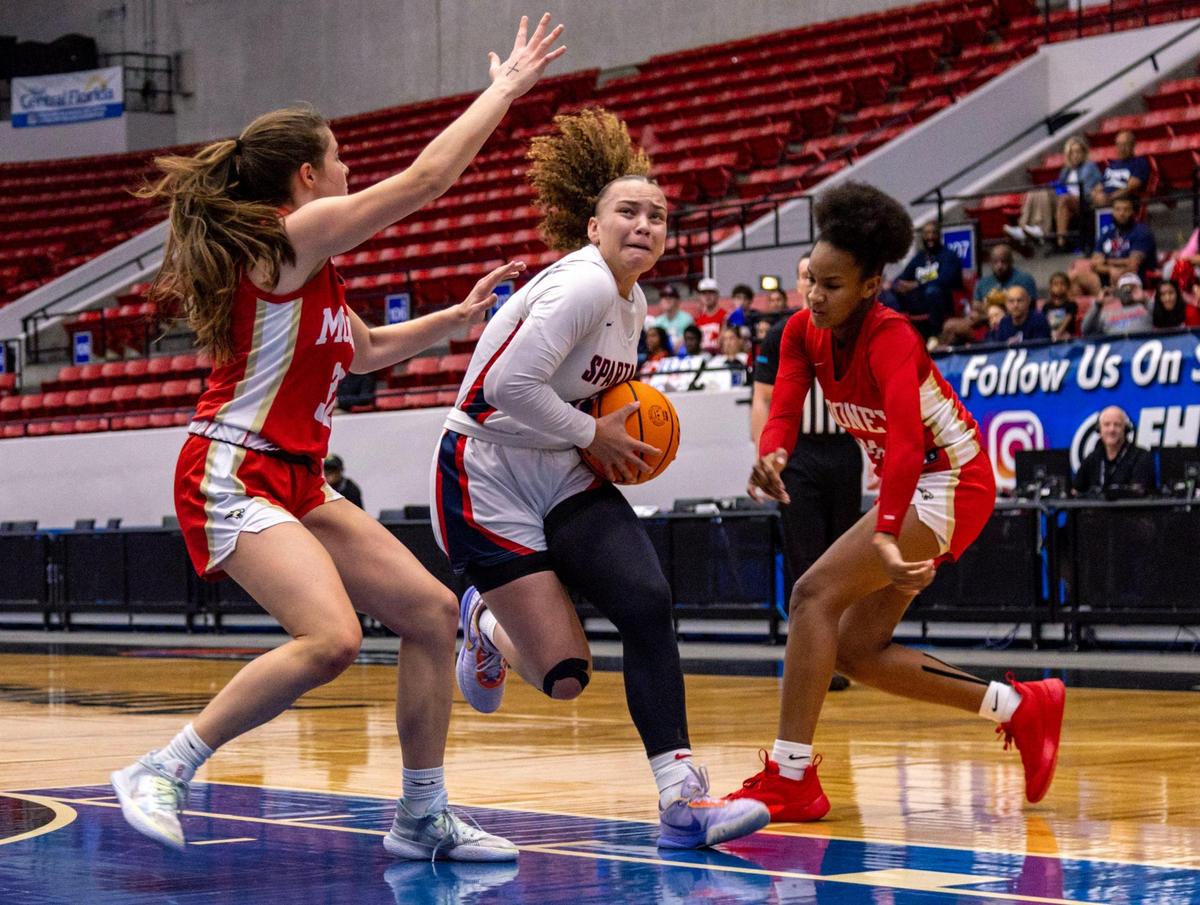 Miami Country Day guard Jalynn Belton (13) drives toward the paint while Cardinal Mooney defenders double her during the Class 3A state Girl’s basketball championship game at RP Funding Center in Lakeland, Florida, on Saturday, February 25, 2023.
