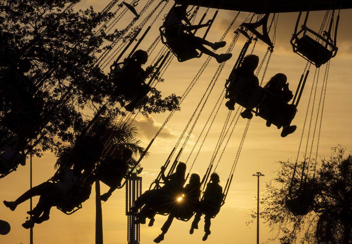 Guest ride on a swing attraction during the opening day of the 74th annual Miami-Dade County Youth Fair on Thursday, March 12, 2026, in Miami, Fla.