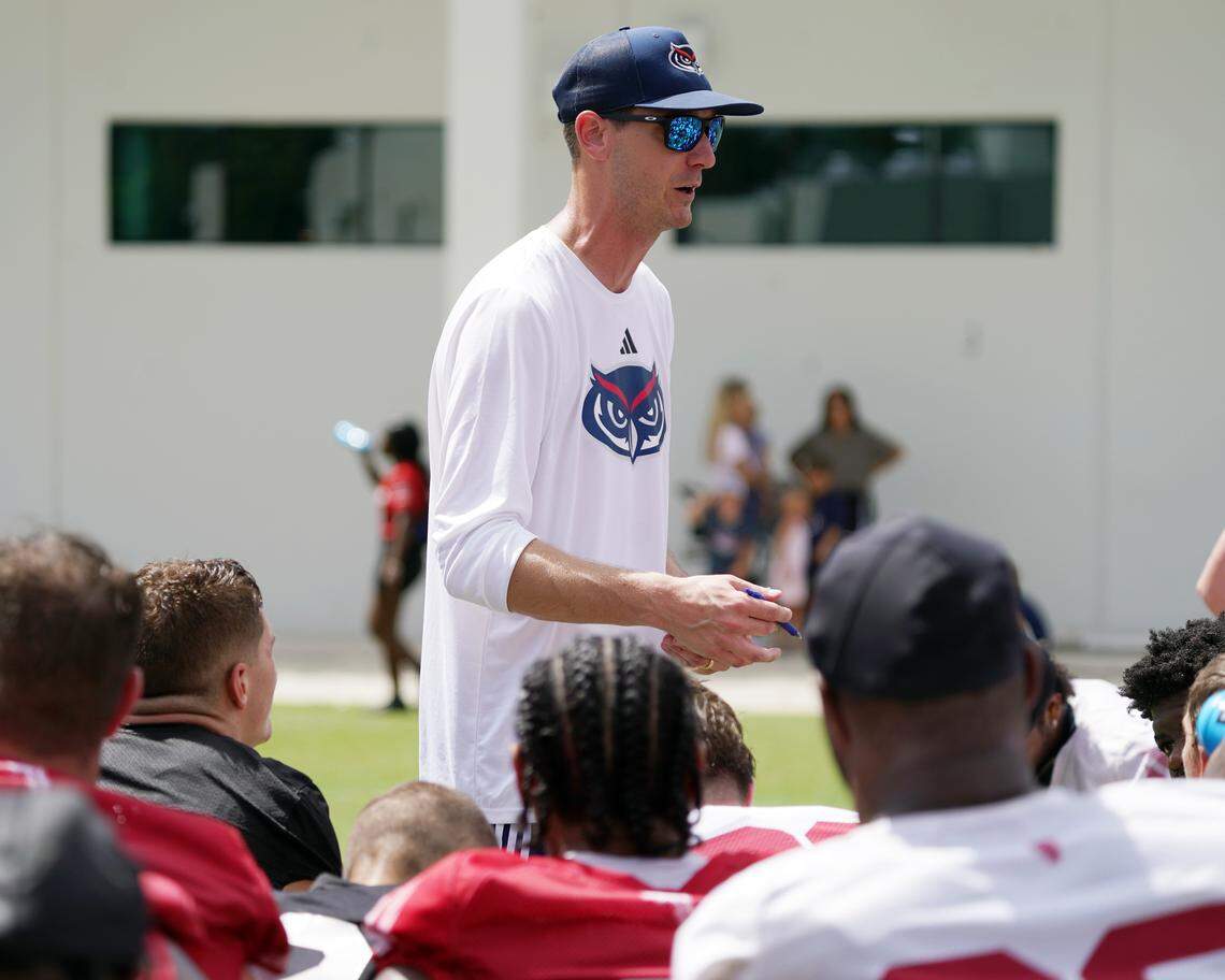 New FAU football coach Zach Kittley speaks to Owls players after a practice this past offseason.