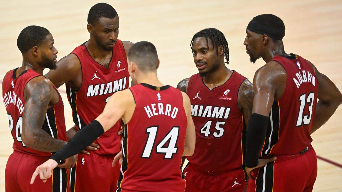 The Miami Heat gather in front of the bench during a timeout in the fourth quarter against the Cleveland Cavaliers at Rocket Arena.