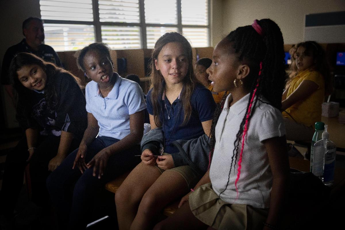 Fourth graders learn the history behind the song “Happy Xmas (war is over)” for their Christmas concert during the Achieve Miami afterschool program, a free music program for kids, on Wednesday, Oct. 18, 2023, at Caribbean K-8 Center in Miami.