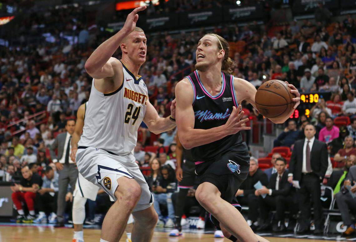 Miami Heat center Kelly Olynyk (9 drives against Denver Nuggets forward Mason Plumlee (24) in the second quarter of an NBA basketball game at AmericanAirlines Arena on Jan. 8.