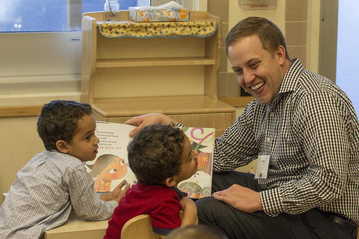 United Way of Miami Dade Young Leader  Carter Young reads to Andres, 3, (left) and Freddy, 4, at the Jumpstart Read for the Red, an international program where people around the world read the same book, on the same day, to children. This year, the group read ‘Maybe Something Beautiful: How Art Transformed a Neighborhood,” by F. Isabel Campoy and Theresa Howell on Thursday, October 25, 2018.