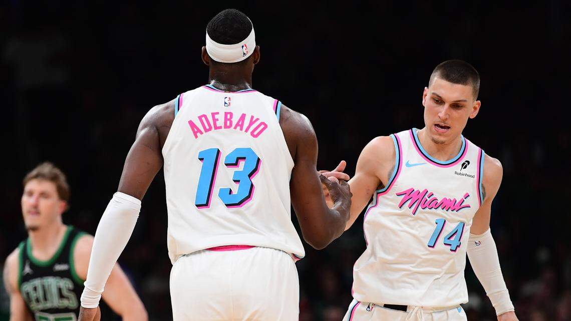 Miami Heat center Bam Adebayo (13) is congratulated by guard Tyler Herro (14) after making a basket during the second half against the Boston Celtics at TD Garden.