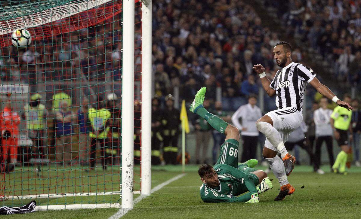 Juventus' Medhi Benatia scores his side's third goal past AC Milan goalkeeper Gianluigi Donnarumma during the Italian Cup final soccer match between Juventus and AC Milan, at the Rome Olympic stadium, Wednesday, May 9, 2018. (AP Photo/Gregorio Borgia)