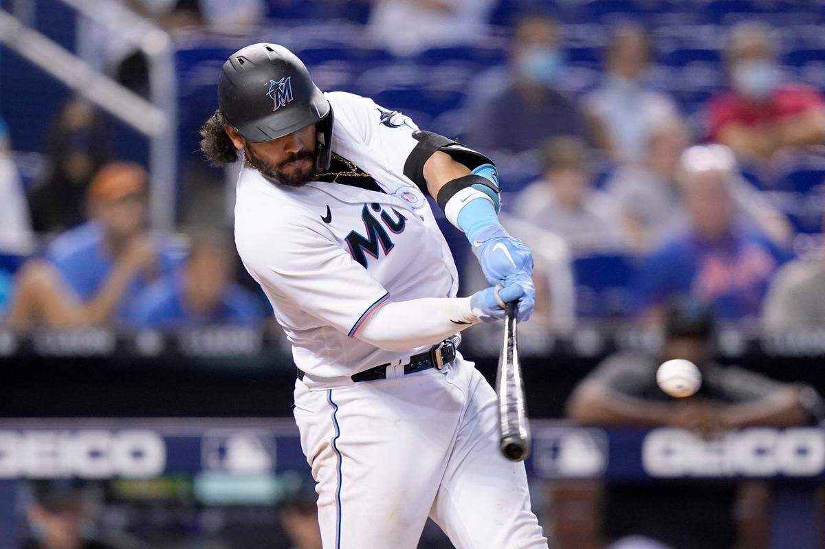 Miami Marlins’ Jorge Alfaro hits an RBI-single to score Miguel Rojas during the eighth inning of a baseball game against the New York Mets, Thursday, Aug. 5, 2021, in Miami. The Marlins won 4-2. (AP Photo/Lynne Sladky)
