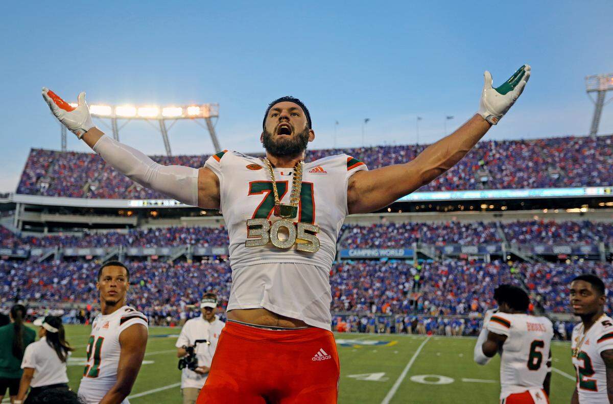Miami Hurricanes defensive lineman Scott Patchan (71) earns the turnover chain on a turnover in the second quarter as the University of Miami plays the University of Florida at Camping World Stadium in Orlando on Saturday, August 24, 2019.