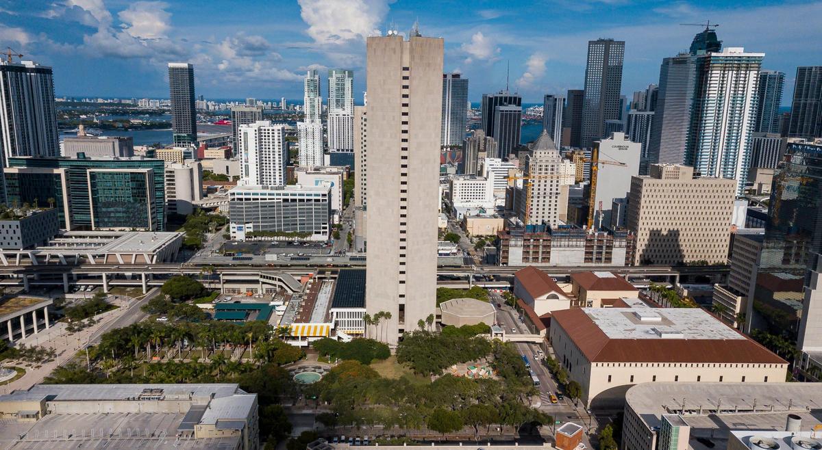 Miami-Dade County is offering public land and buildings surrounding its Stephen P. Clark Government Center tower to developers as part of a plan to create a new downtown neighborhood. The properties up for bid include green space and annex buildings next to the tower, which would remain, as well as the Miami-Dade Cultural Center, at right, which would be demolished and replaced. The octagonal commission chambers visible at the tower’s base would be replaced elsewhere.