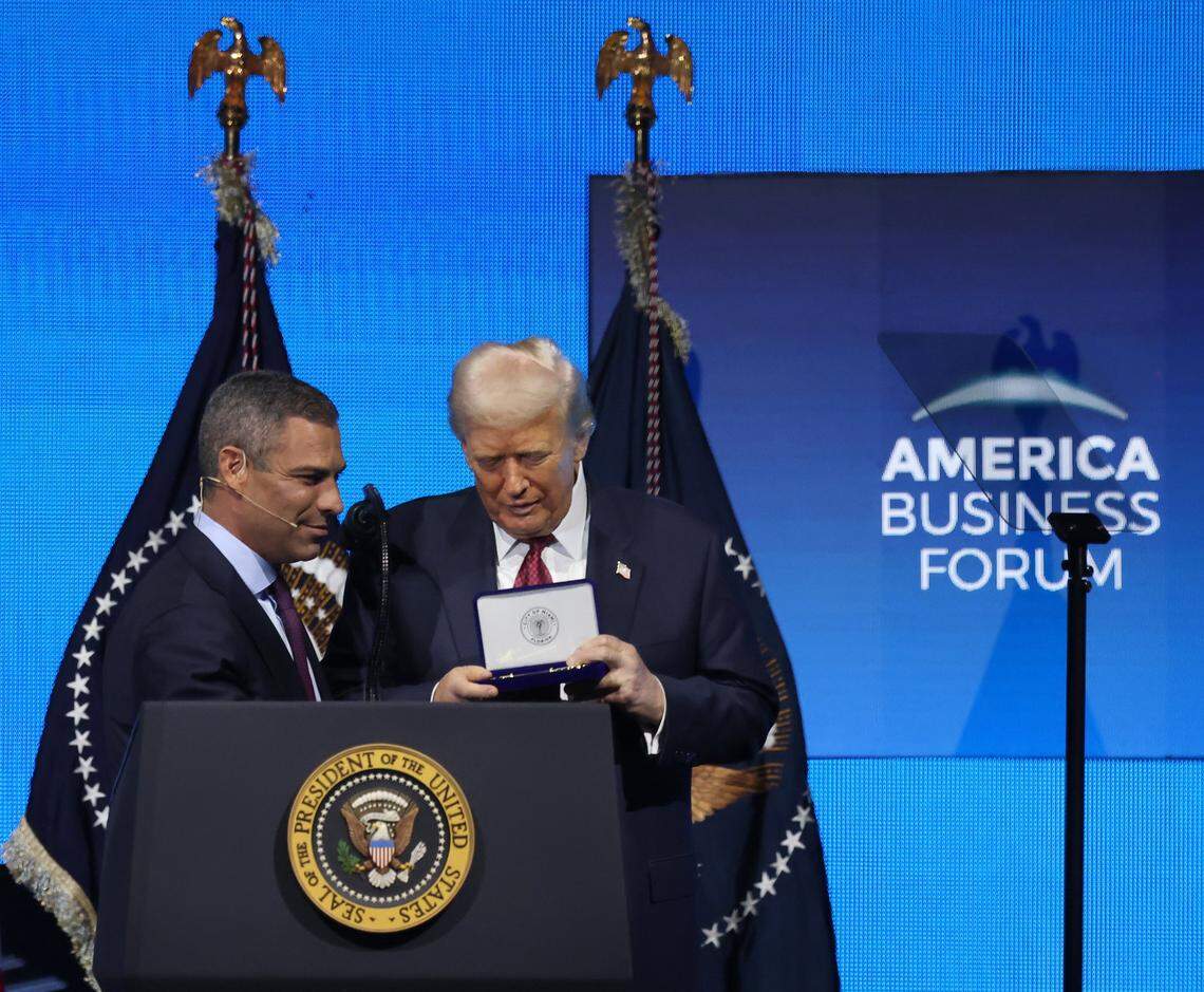 Mayor Francis Suarez, left, gives President Donald J. Trump the “Key-to-the-City” while he addressed the attendees of the American Business Forum at the Kaseya Center in Miami, Florida on Wednesday, November 5, 2025.