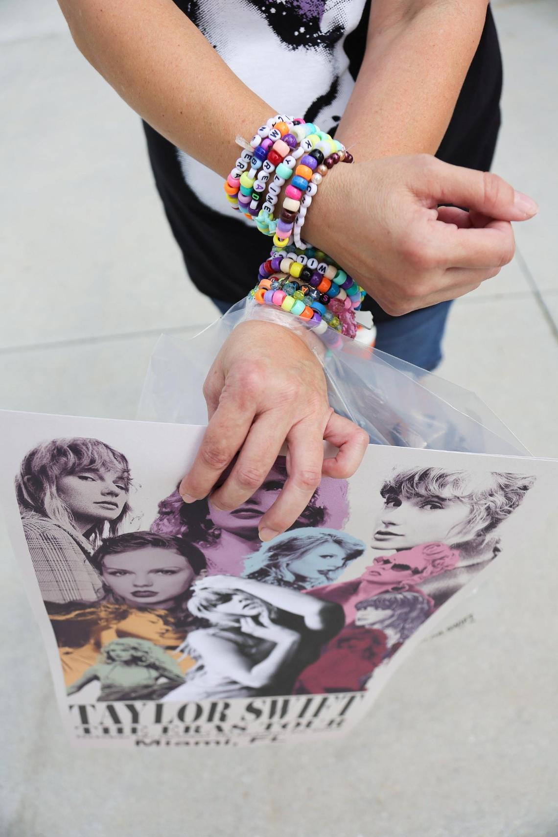 Janier Sideregts, 47, shows her Taylor Swift bracelets after visiting the Taylor Swift Eras Tour merchandise store at Hard Rock Stadium in Miami Gardens, Florida, Wednesday, October 16, 2024.