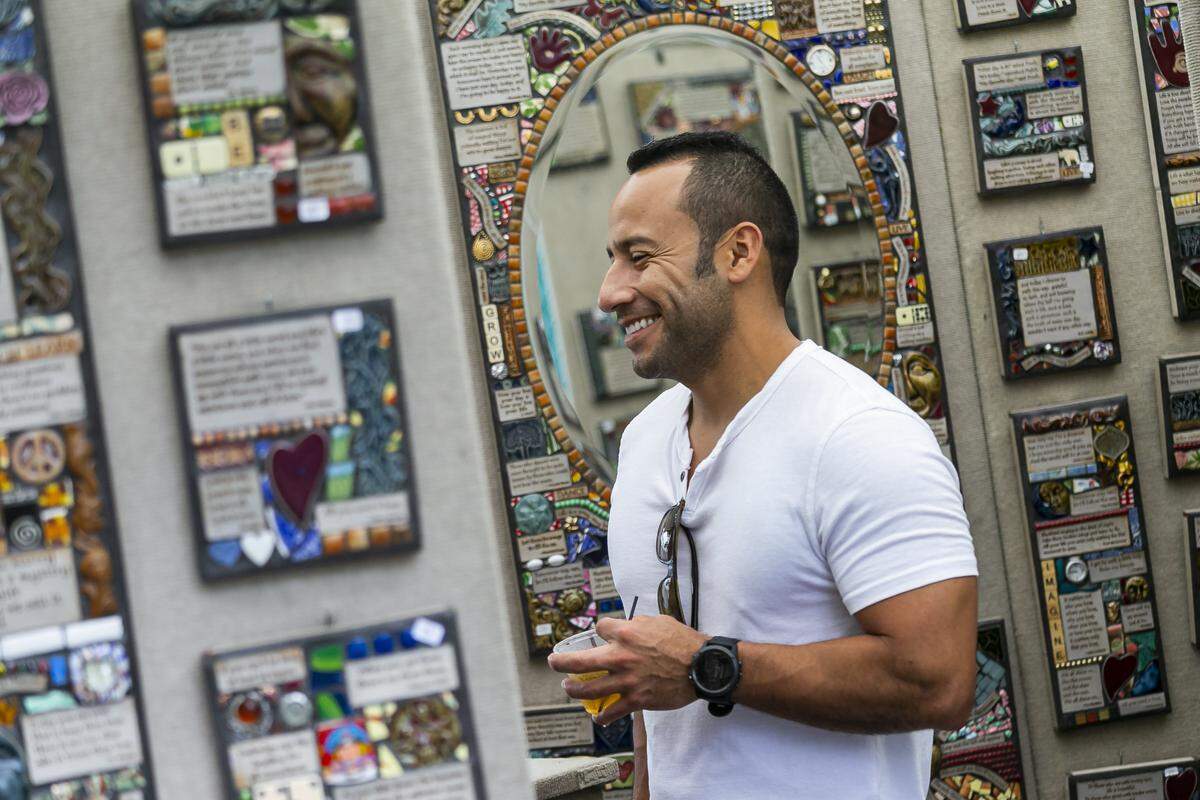 Jose Martinez of Homestead enjoys the work of Greg and Mindy Rhoads at the 2020 Coconut Grove Arts Festival.