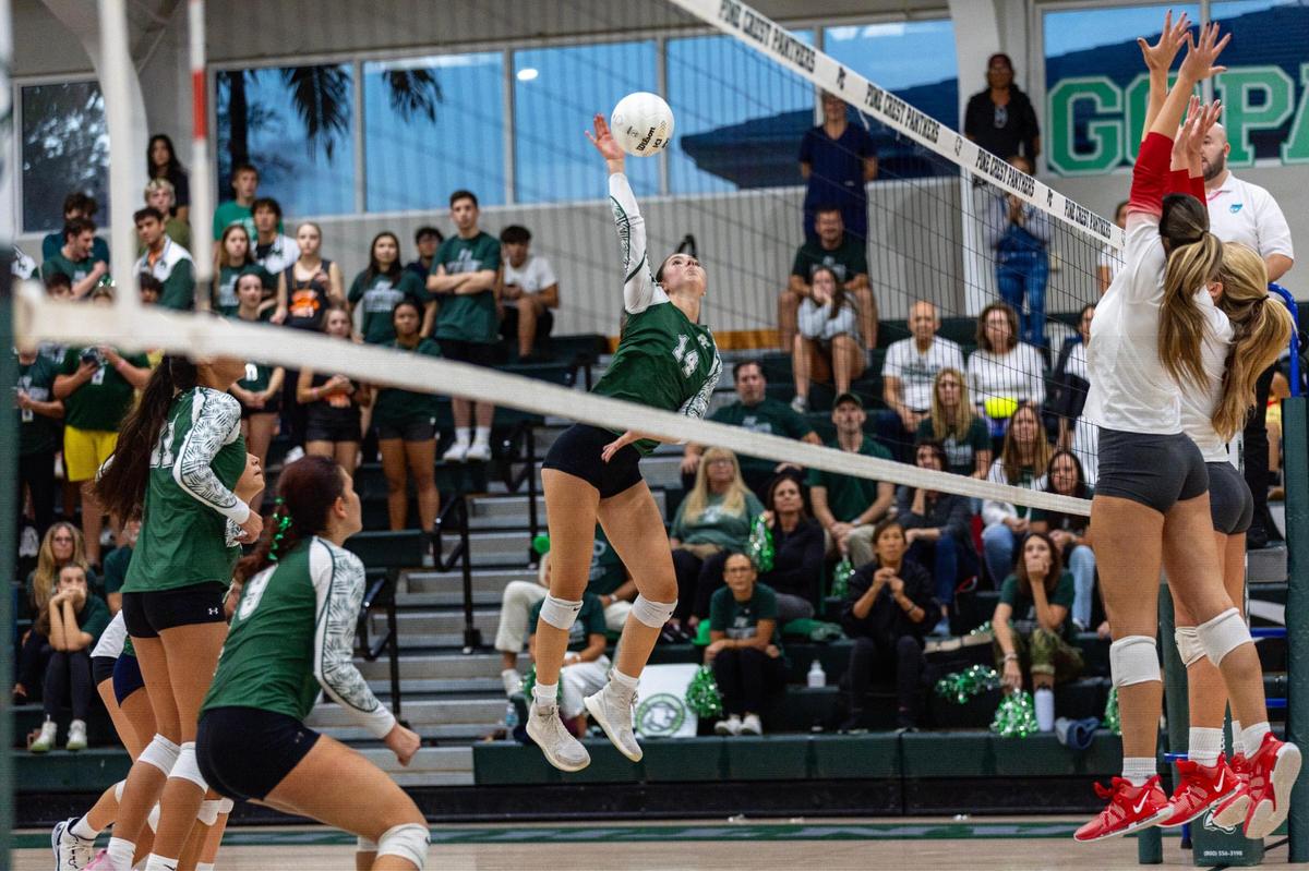 Pine Crest Panthers’ outside hitter Mia Gold (14) strikes the ball during a regional semifinal playoff volleyball match against Cardinal Gibbons at Pine Crest School campus in Fort Lauderdale, Florida, on Thursday, October 26, 2023.