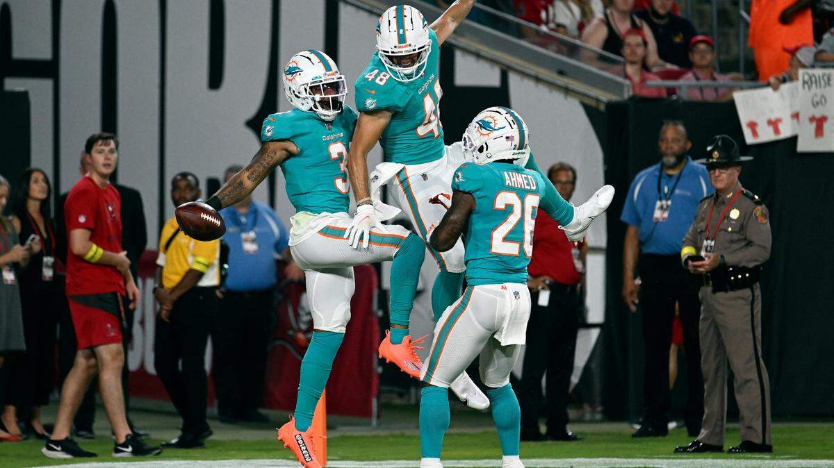 Miami Dolphins wide receiver Lynn Bowden Jr. (3) celebrates his touchdown against the Tampa Bay Buccaneers with tight end Tanner Conner (48) and running back Salvon Ahmed (26) during the first half of an NFL preseason football game Saturday, Aug. 13, 2022, in Tampa, Fla.