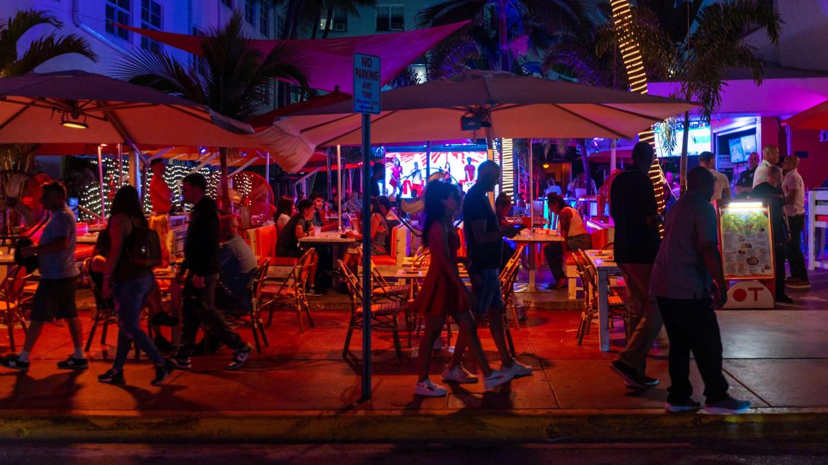 People walk along Ocean Drive in Miami Beach, Florida, on Friday, March 3, 2023.