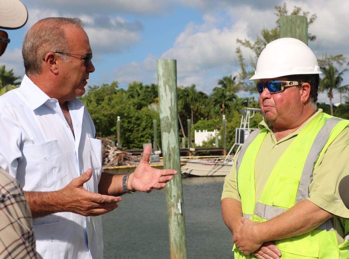 Greg Tolpin, on the right,from Adventure Environmental, Inc., a Tavernier-based company, talks about the project with County Administrator Roman Gastesi.
