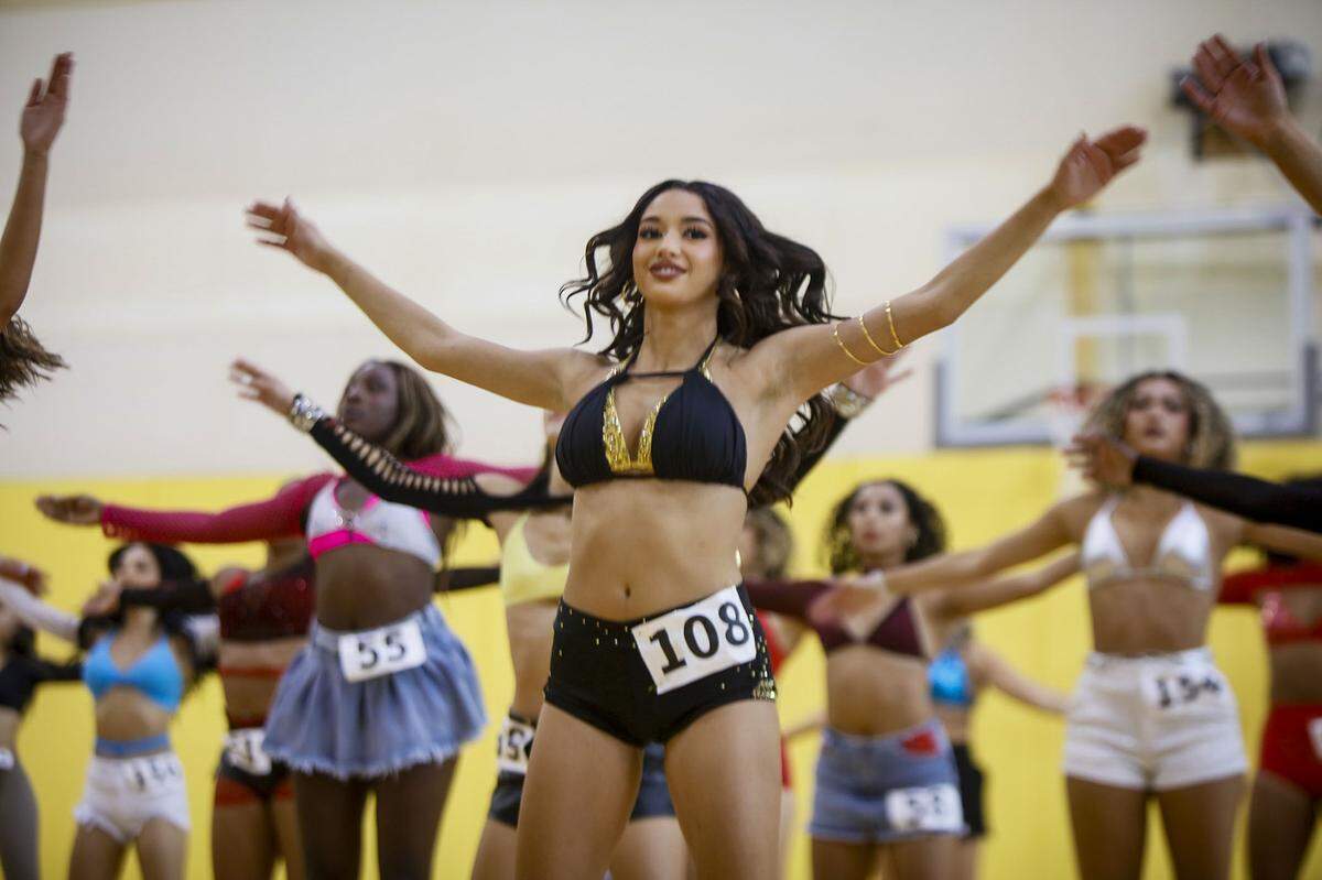 Arielle Lopez, center, goes through the routines during auditions.