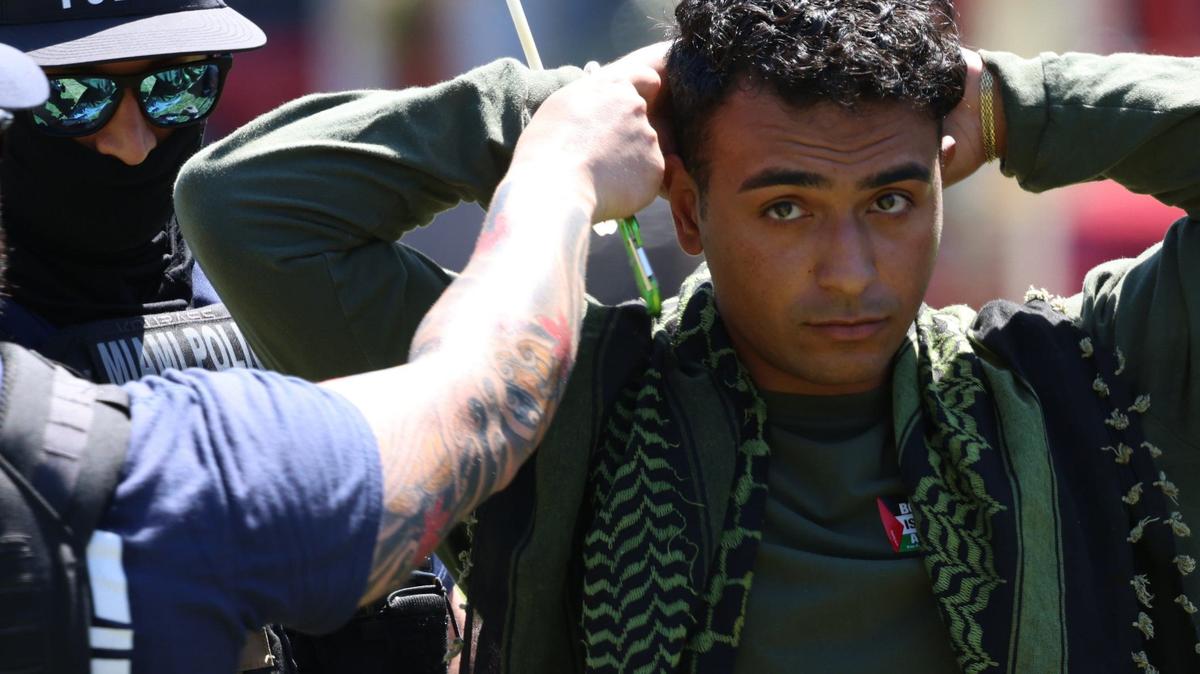 Police arrest a man taking part in a pro-Palestine protest in downtown Miami Monday, April 15, 2024. Police say seven people were arrested after blocking traffic.