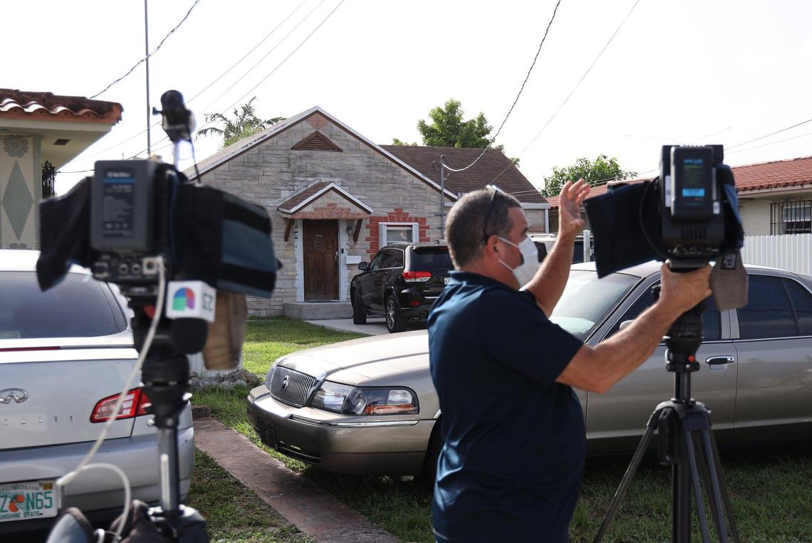 Members of the press wait outside the home Thursday afternoon where a 16-year-old South Miami High School student lives. The student, whom the Herald is not naming because he is a minor, was arrested early Thursday morning and charged with a felony and a misdemeanor charge in connection with some of the cyberattacks on Miami-Dade Public Schools.