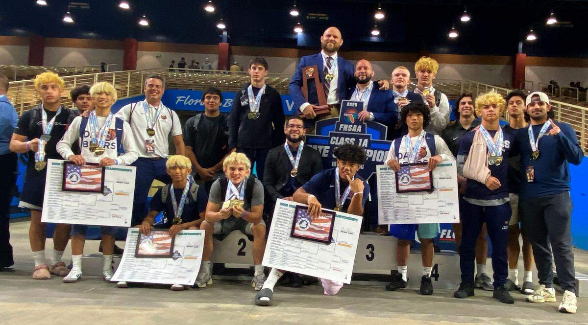 Mater Lakes wrestlers and coaches pose after winning the Class 1A state title on Saturday at the FHSAA IBT wrestling state championships at Silver Spurs Arena in Kissimmee.