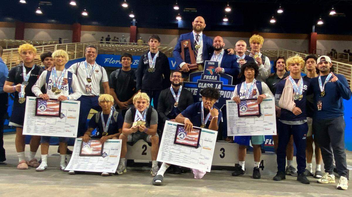 Mater Lakes wrestlers and coaches pose after winning the Class 1A state title on Saturday at the FHSAA IBT wrestling state championships at Silver Spurs Arena in Kissimmee.