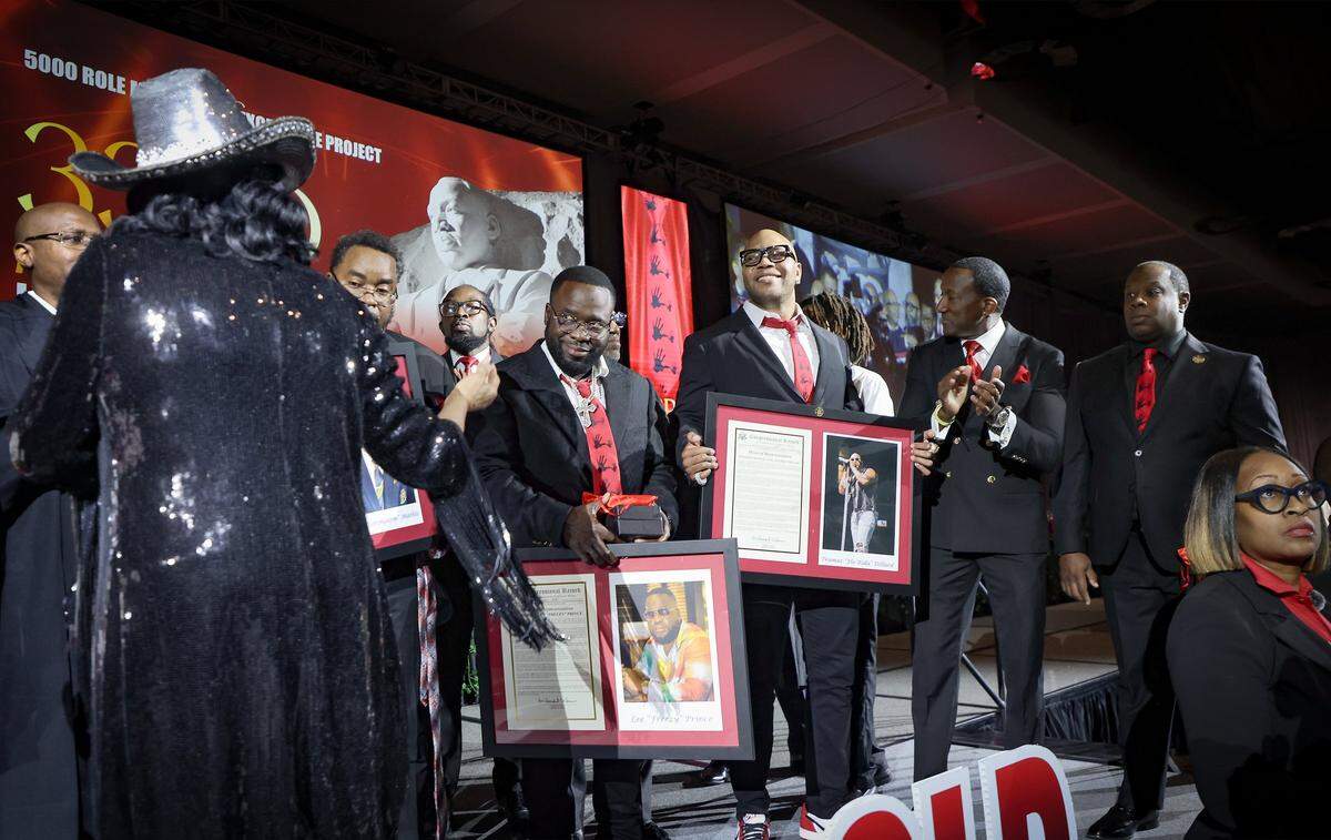 2026 Headliners Lee “Freezy Prince” Prince, looks in the direction of Congresswoman Frederica Wilson, left, as she presents Congressional Records to him, Tramar Lacey “Flo Rida” Dillard, and other headliners during the Annual Scholarship Breakfast. The 5000 Role Models held its 33rd Annual Dr. Martin Luther King, Jr. Annual Scholarship Breakfast with Keynote Speaker Bishop Neil C. Ellis, and the 2026 Headliners consisting of Lee “Freezy Prince” Prince, Tramar “Flo Rida” Lacel Dillard, Maurice “Trick Daddy” Samuel Young, and Khaled “ DJ Khaled” Mohammed Khaled, on Monday, January 19, 2026, at the Miami Beach Convention Center, in Miami Beach, Florida. 