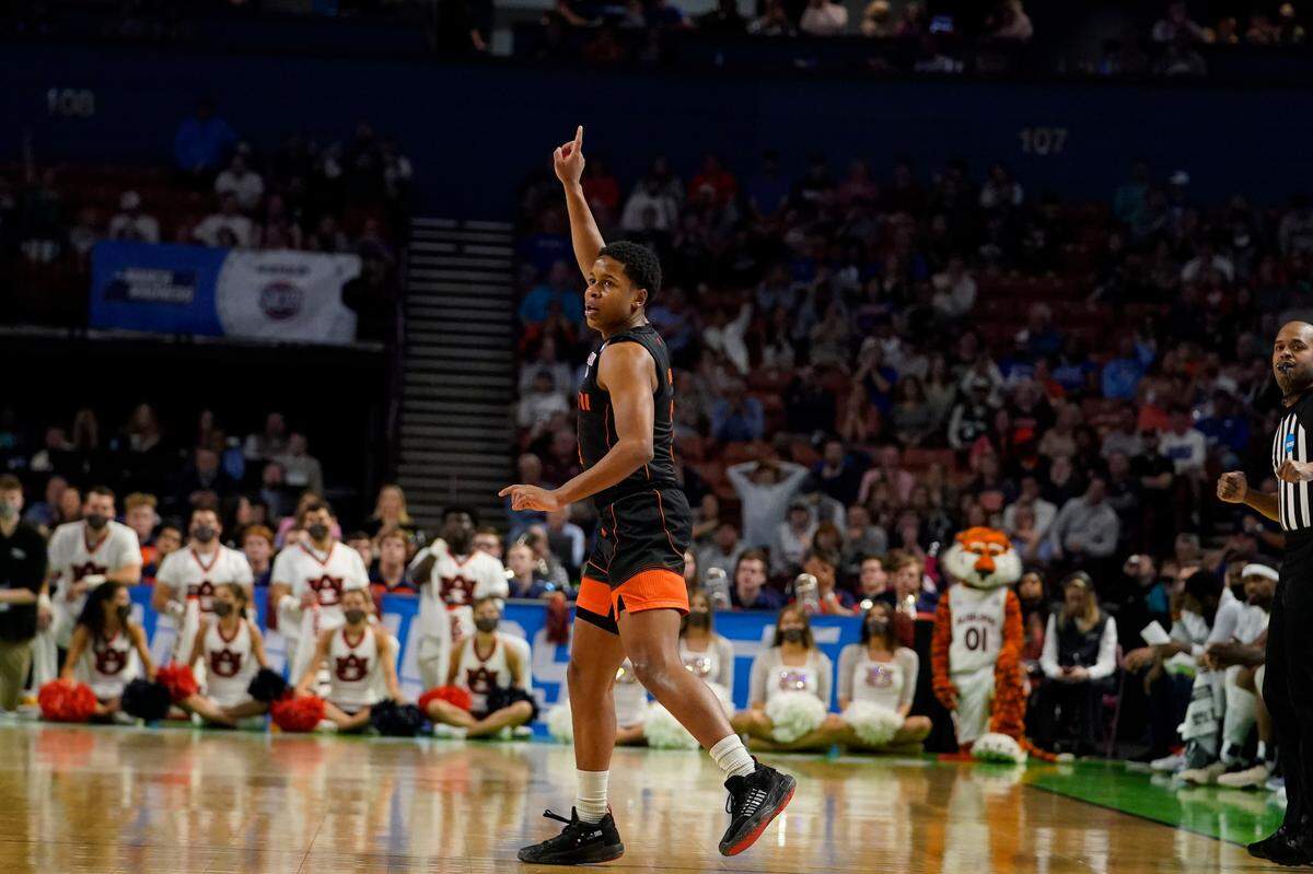 Miami guard Charlie Moore (3) celebrates after scoring during the second half of a college basketball game against Auburn in the second round of the NCAA tournament Sunday, March 20, 2022, in Greenville, S.C.