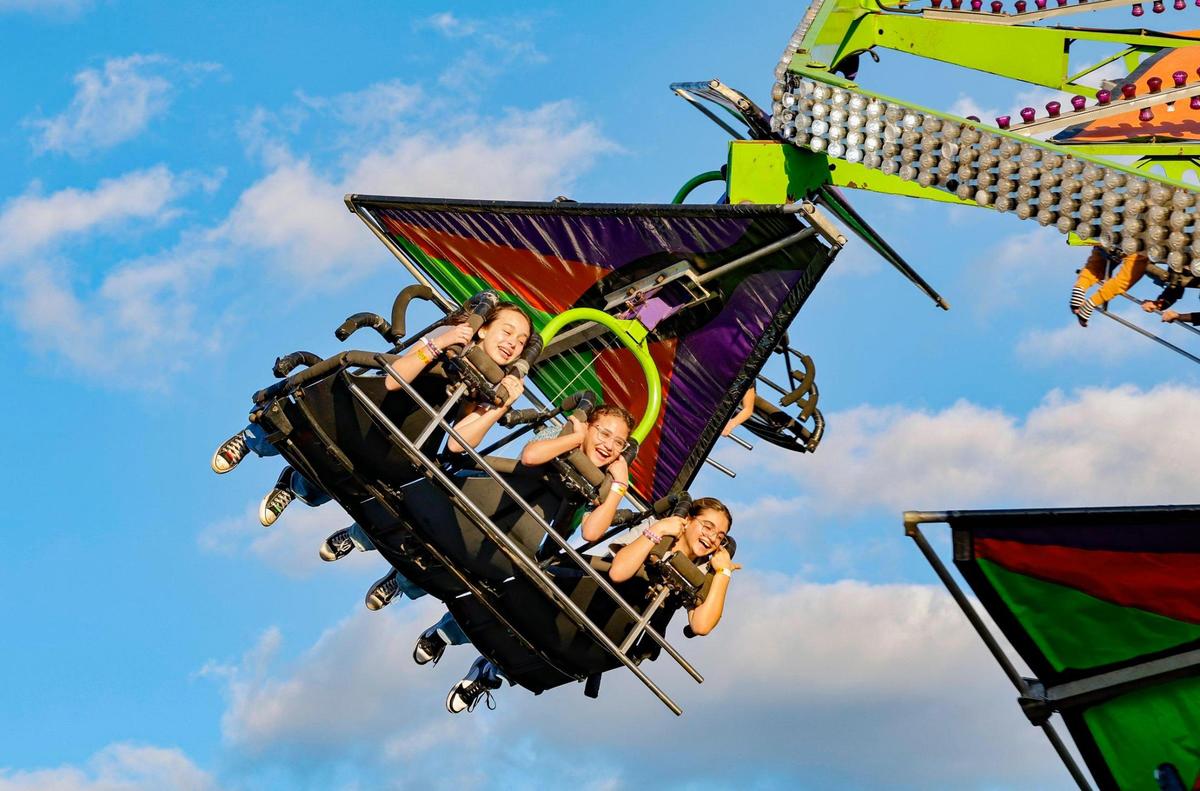 Fairgoers ride the Cliff Hanger at the opening day of the Miami-Dade County Fair & Exposition.