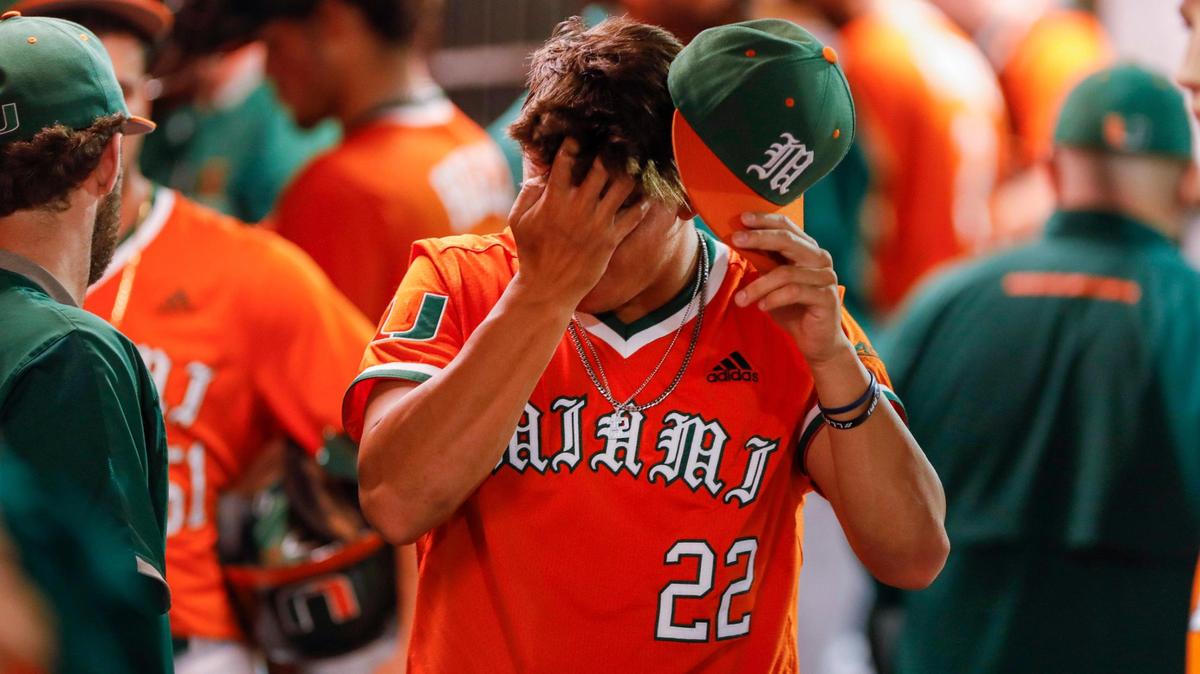 Miami Hurricanes pitcher Anthony Arguelles (22) covers his face with his hand after UM loses the game against the Arizona Wildcats during the Coral Gables NCAA Baseball Regional at Alex Rodriguez Park at Mark Light Field in Coral Gables, Florida, Sunday, June 5, 2022.