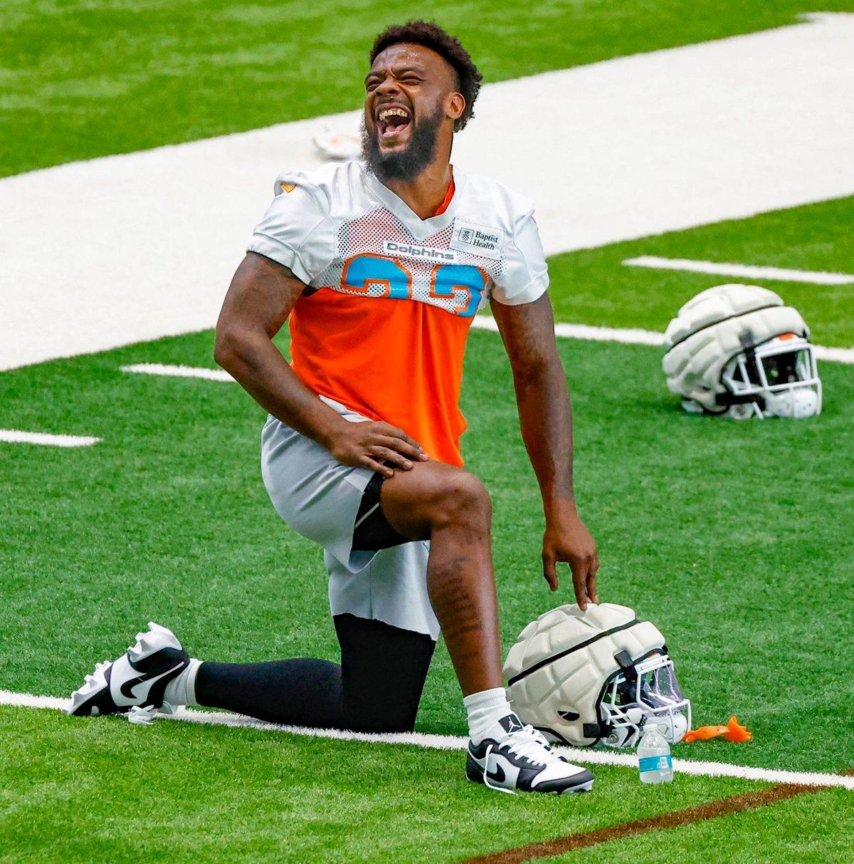 Miami Dolphins running back Jeff Wilson Jr. (23) stretches during warmups before practice drills at the Baptist Health Training Complex in Miami Gardens on Wednesday, October 11, 2023.