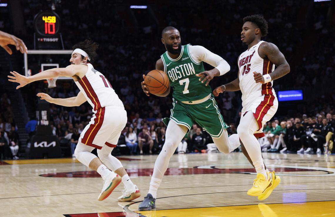 Boston Celtics guard Jaylen Brown (7) dribbles around Miami Heat guard Davion Mitchell (45) and forward Jaime Jaquez Jr. (11) during the second half of a game on April 1, 2026, at Kaseya Center in Miami.