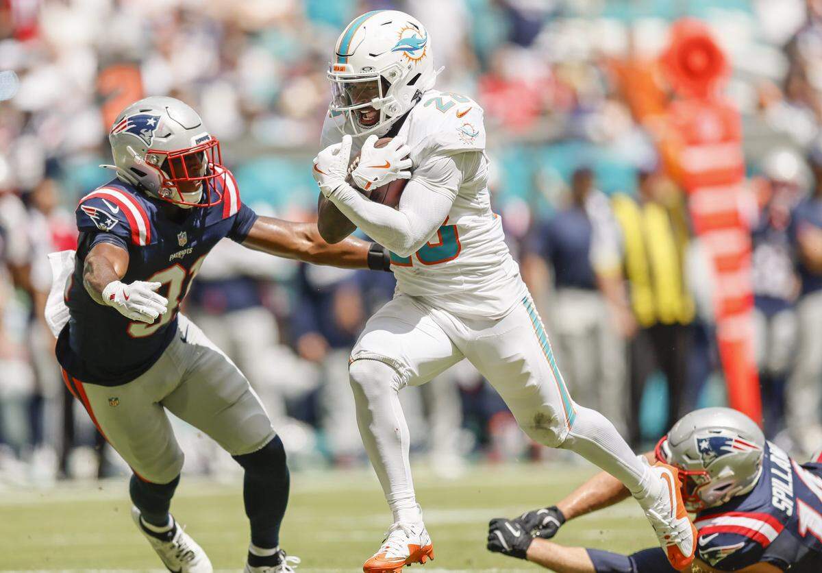 Miami Dolphins running back De'Von Achane (28) scores against the New England Patriots in the first half of an NFL football game at Hard Rock Stadium in Miami Gardens, Florida, on Sunday, September 14, 2025. 