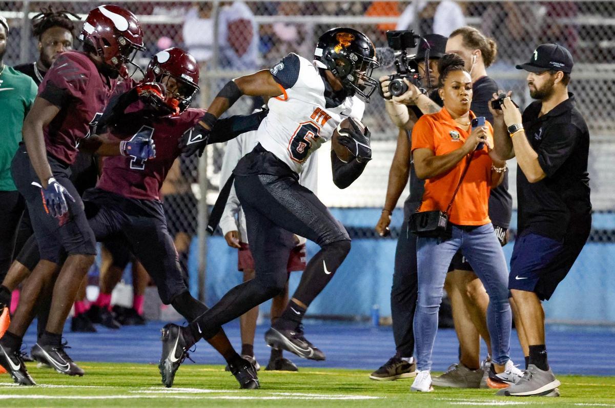 Booker T. Washington’s running back Gerald Modest (6) runs for a first down against Miami Norland defenders in the first half at Traz Powell Stadium in Miami on Thursday, October 5, 2023.