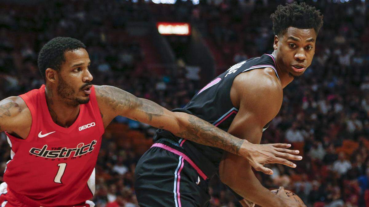 Miami Heat center Hassan Whiteside (21) looks to pass around the Washington Wizards forward Trevor Ariza (1) in the first quarter as the Miami Heat host the Washington Wizards at the AmericanAirlines Arena in Miami on Friday, January 4, 2019.