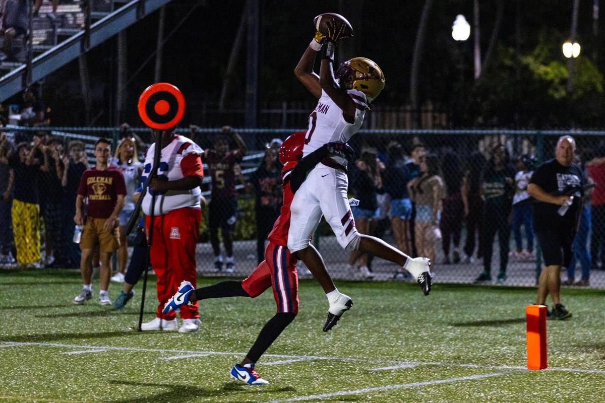 Goleman Gators wide receiver Darryl Bell (0) ctaches the ball over an American defensive back during a high school football game at Milander Park in Homestead, Florida, on Friday, September 8, 2023.