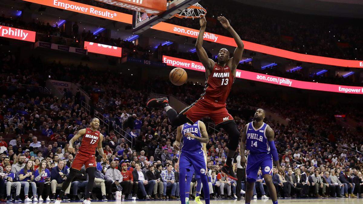 Miami Heat’s Bam Adebayo (13) dunks the ball past Philadelphia 76ers’ Jonathon Simmons (14) and Jonah Bolden (43) during the first half of an NBA basketball game Thursday, Feb. 21, 2019, in Philadelphia. (AP Photo/Matt Slocum)