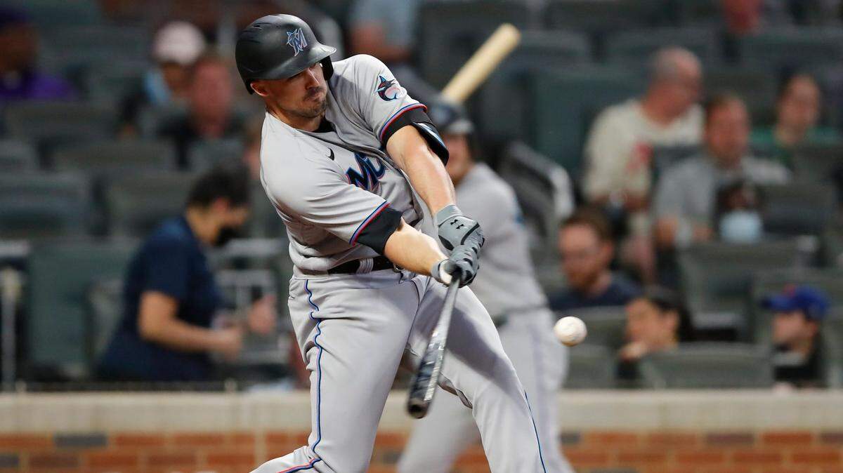 ATLANTA, GA - APRIL 13: Adam Duvall #14 of the Miami Marlins hits a two-run double in the fourth inning of an MLB game against the Atlanta Braves at Truist Park on April 13, 2021 in Atlanta, Georgia. (Photo by Todd Kirkland/Getty Images)