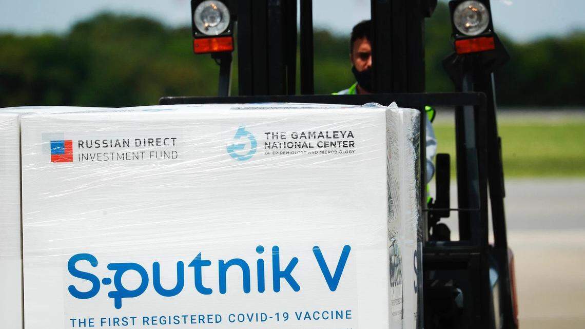 In January, an airport worker in Ezeiza, Argentina, uses a forklift to carry a container with doses of Sputnik V vaccine sent by Russia.