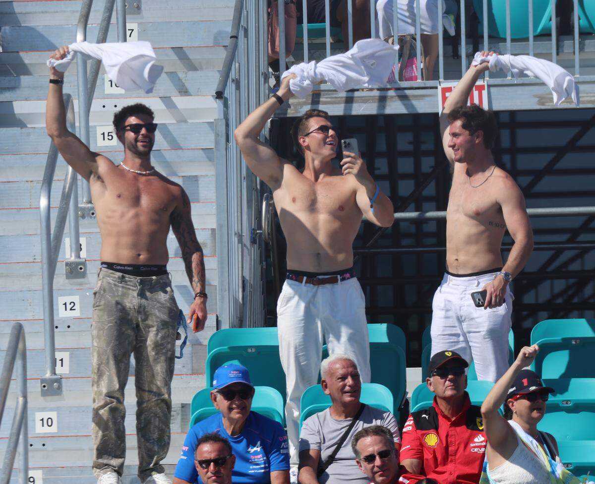 Fans twirl their t-shirts in the grandstand on Turn 1 during the qualifying session on second day of the Formula One Miami Grand Prix at the Miami International Autodrome on Saturday, May 2, 2026, in Miami Gardens, Fla.