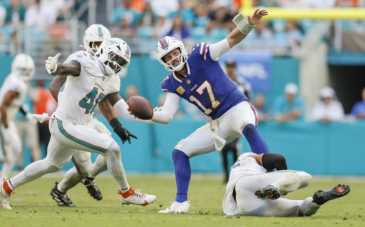Miami Dolphins safety Minkah Fitzpatrick (29) trips up Buffalo Bills quarterback Josh Allen (17) for the sack in the second half of an NFL football game at Hard Rock Stadium in Miami Gardens, Florida on Sunday, November 9, 2025.
