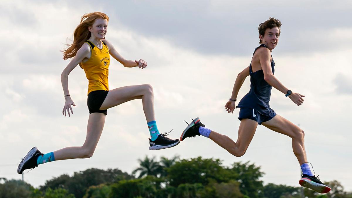 Broward Cross Country Players of the Year Ashley Fitzgerald, from American Heritage, and Martin Goodwin, from St. Thomas Aquinas, are photographed at Brian Piccolo Park in Hollywood, Florida on Friday, January 7, 2022.