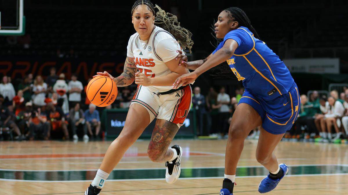 Miami Hurricanes center Jessica Peterson (35) drives to the b basket against Hofstra Pride center Michaela Hodge (32) during the second quarter at Watsco Center, in Coral Gables, Florida, Monday, November 3, 2025. 