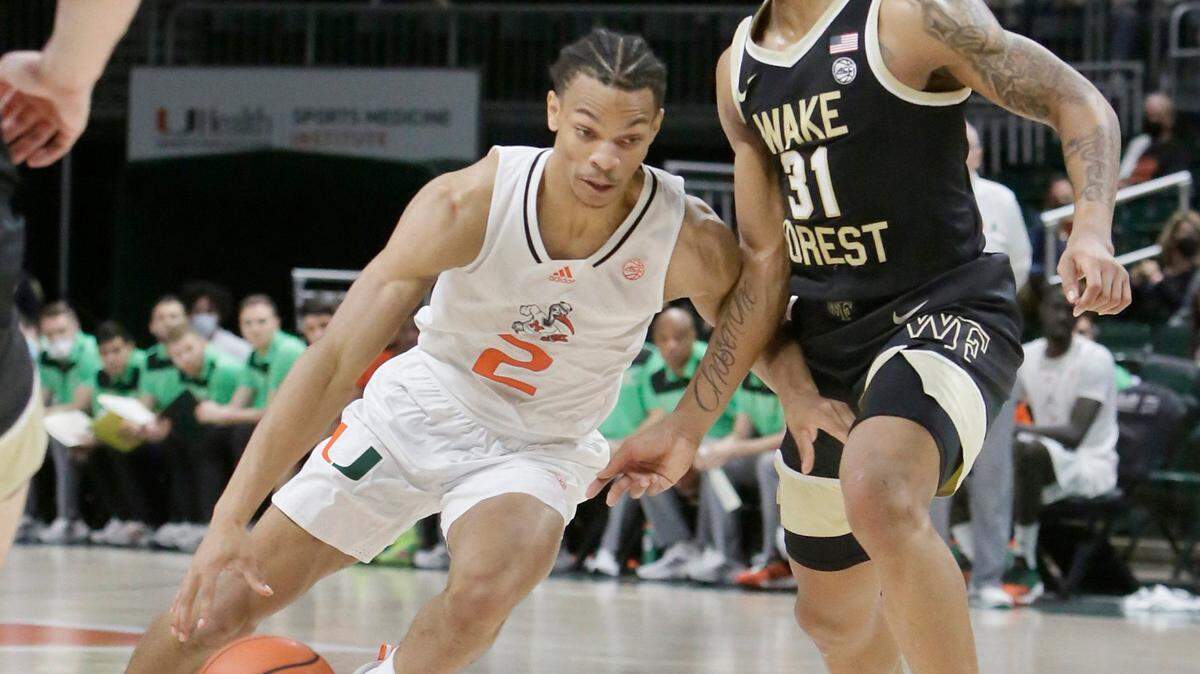 UM Hurricanes Isaiah Wong (2) slides around Wake Forest Deacons Alondes Williams during basketball game on January 1, 2022 at Watsco Center in Coral Gables. Andrew Uloza / for THE MIAMI HERALD