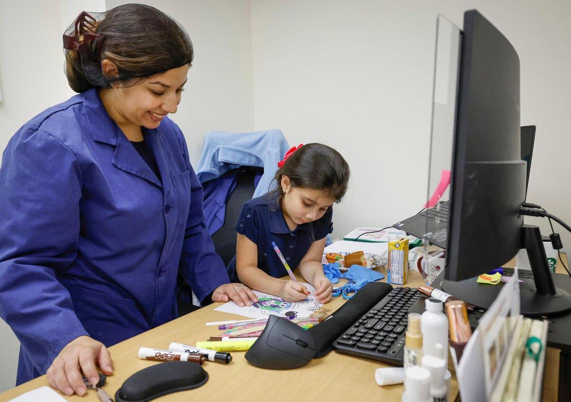 Madelaine Escobar Duran, head cosmetic chemist at Concept II, spends time with her daughter Emily Valdez, 5, during a break from work in Doral, Florida, on Thursday, Oct. 24, 2024.