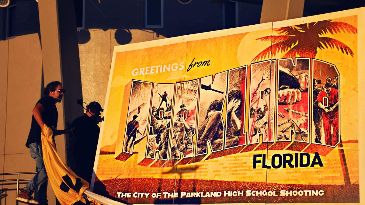 Manuel Oliver, father of Parkland shooting victim Joaquin Oliver, unveils a traveling mural of a Parkland postcard with images depicting the Feb. 14, 2018, shooting at Marjory Stoneman Douglas High School. which resulted in the deaths of 17 students and faculty members. The event was part of a “Shamecards” campaign to push for anti-gun-violence legislation on Thursday, Feb. 12, 2021.