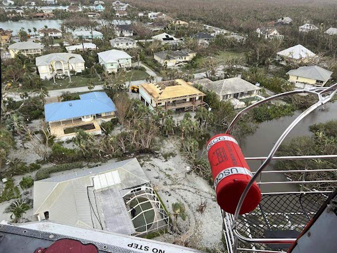 A U.S. Coast Guard aircrew hoists people from flooded areas near Sanibel, Florida, in the wake of Hurricane Ian, Sept. 29, 2022. Crews continue to conduct search and rescue operations in affected areas.