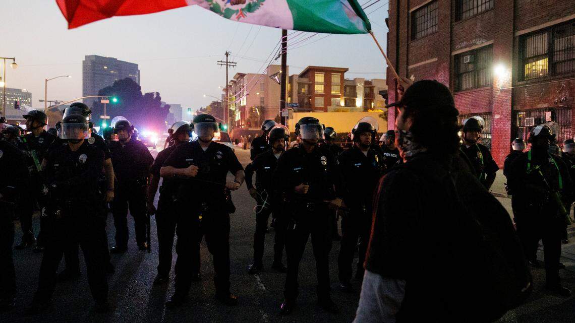 Los Angeles Police Department officers work on controlling the remaining protesters in downtown LA, Calif., on June 9.
